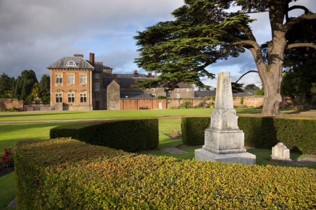 The south west front of Tredegar House, Newport, South Wales, viewed from the Cedar Garden. The house is a fine example of a late seventeenth century mansion. The stone obelisk within the hedge was erected to the memory of `Sir Briggs', the horse that carried Godfrey Morgan, at the famous Charge of the Light Brigade in 1854.